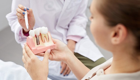 Smiling Orlando patient learning about dental implant benefits