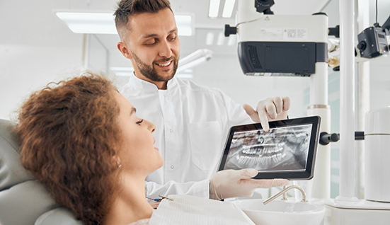 Dentist showing a patient an x ray of their teeth