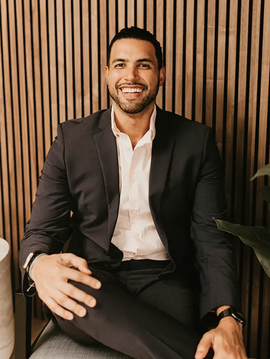 Orlando dentist Doctor Cesar Rodriguez smiling in a white lab coat