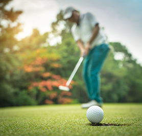 Hand holding a remote in front of a television