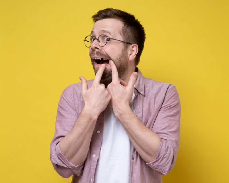 Man showing missing back tooth